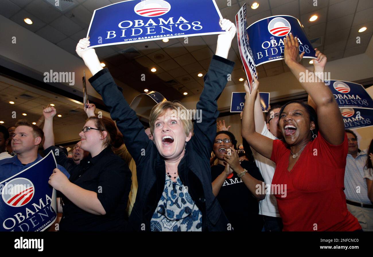 Lisa Schulze, left, and Angela Gant, right, celebrate after Democratic  presidential candidate Barack Obama was declared the winner as they watch  election results at a Harris County Democratic election night party Tuesday,