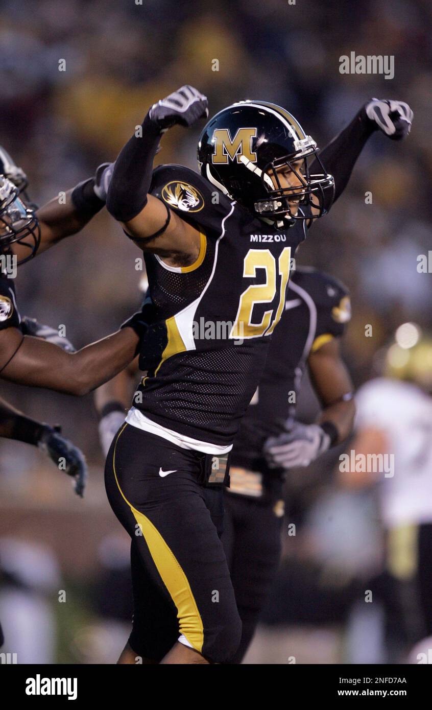 Missouri defensive back Castine Bridges (21) knocks the ball loose from Oklahoma  State wide receiver Dez Bryant (1) as Missouri defensive lineman Stryker  Sulak (38) looks on during the first quarter of