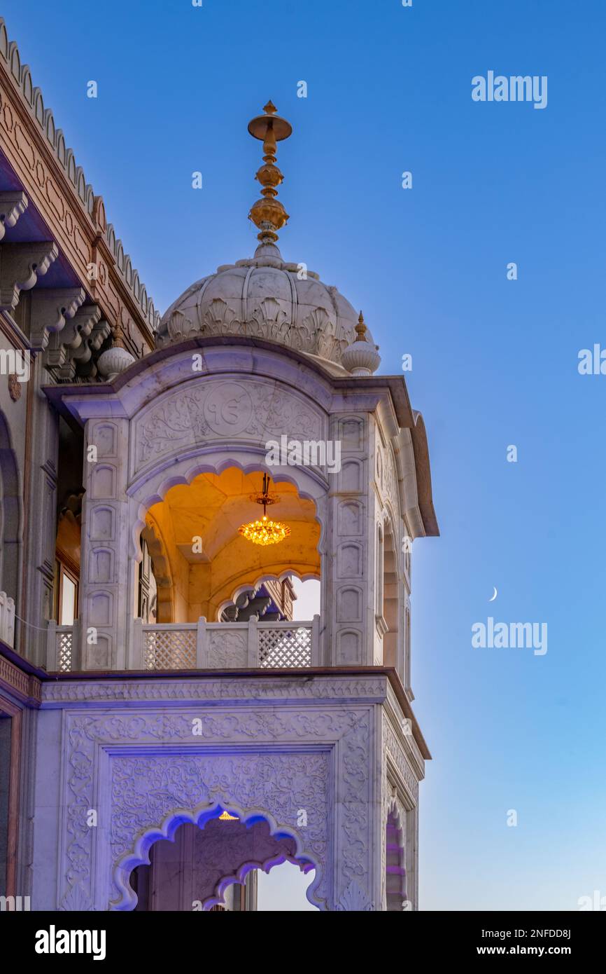 The moon in the sky behind a tower of the Siri Guru Nanak Darbar Gurdwara Gravesend Kent Stock Photo
