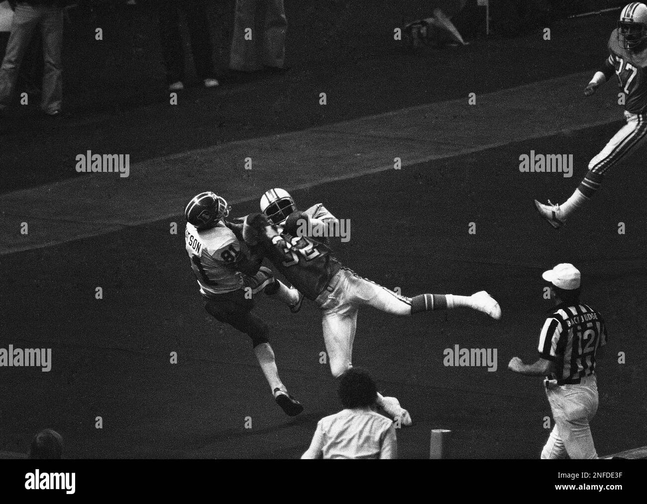 Houston Oilers' Vernon Perry (32) breaks up the fourth quarter pass  intended for Denver Broncos Steve Watson (81) in the NFL playoff game at  Houston on Sunday Dec. 23, 1979. The pass