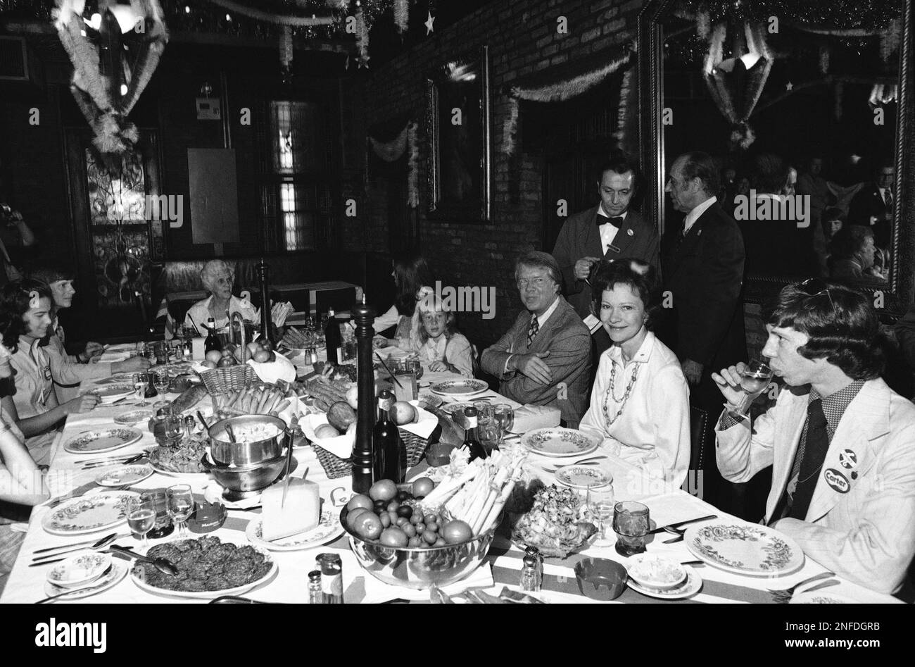 Jimmy Carter, seated at right center, and members of his family settle ...