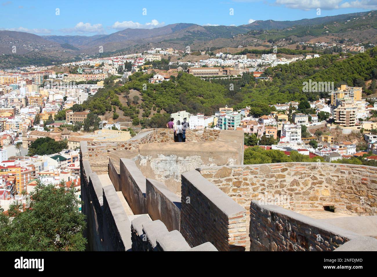 MALAGA, SPAIN - OCTOBER 11, 2010: Tourists visit viewpoint lookout of Gibralfaro fortress walls in Malaga, Spain. Stock Photo