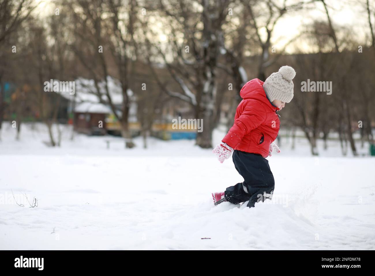 Children play outside in the winter. Snow games in the street Stock