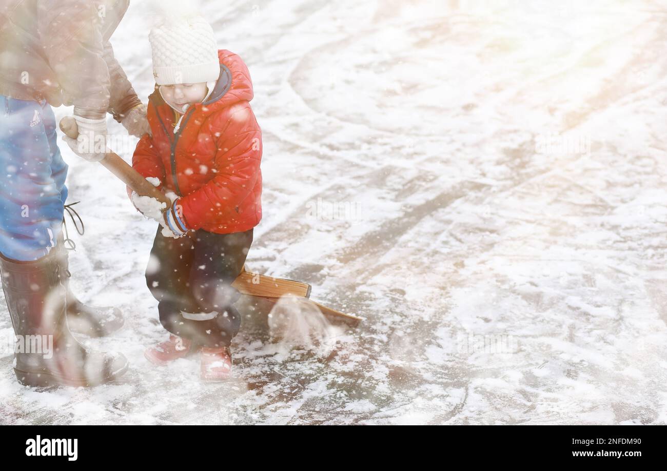 Children play outside in the winter. Snow games in the street Stock