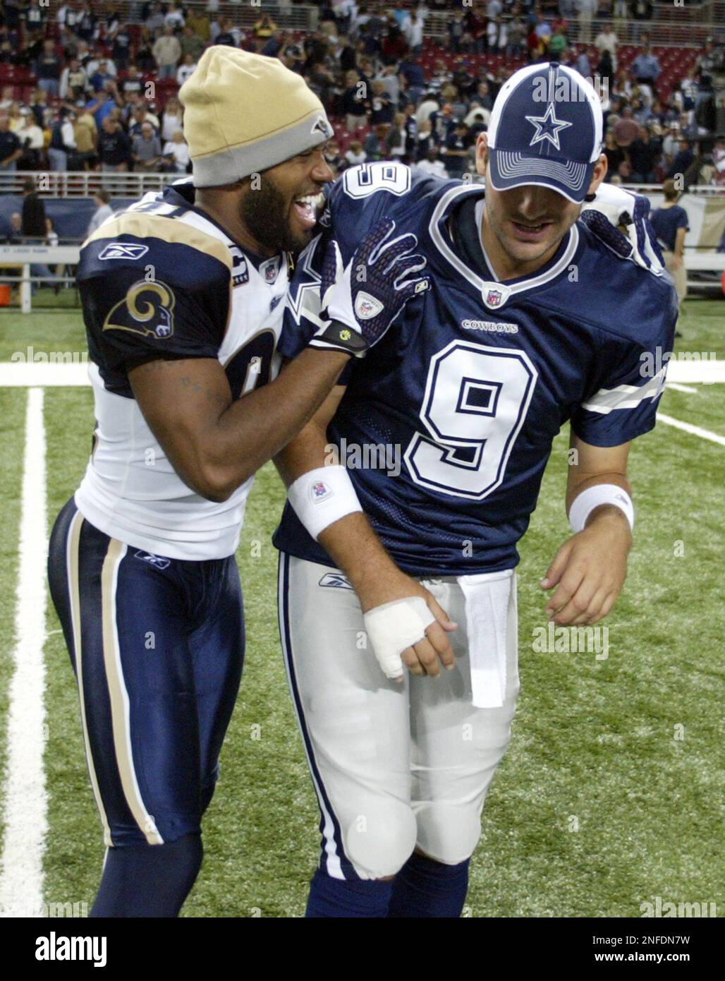 St. Louis Rams wide receiver Torry Holt, left, jokes with Dallas ...