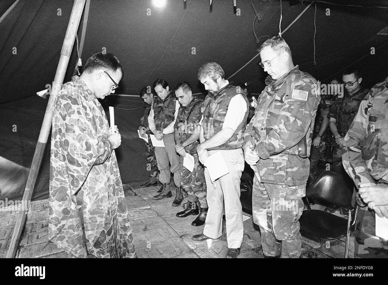 U.S. Navy Chaplain Lt. Thomas Falkenthal, left, leads the Thanksgiving