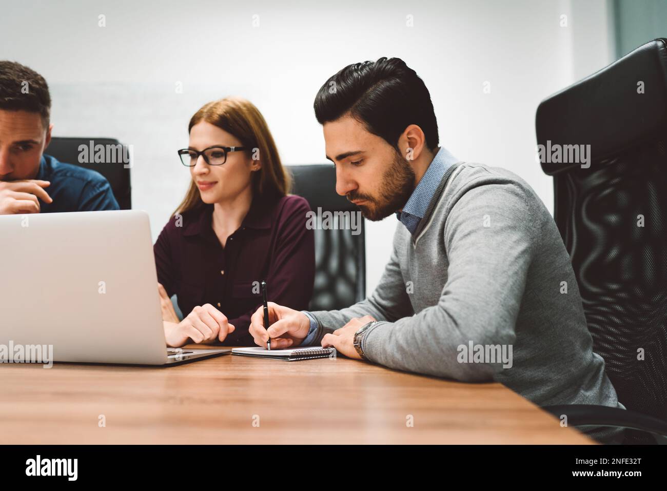 Three young professionals brainstorming ideas hi-res stock photography ...