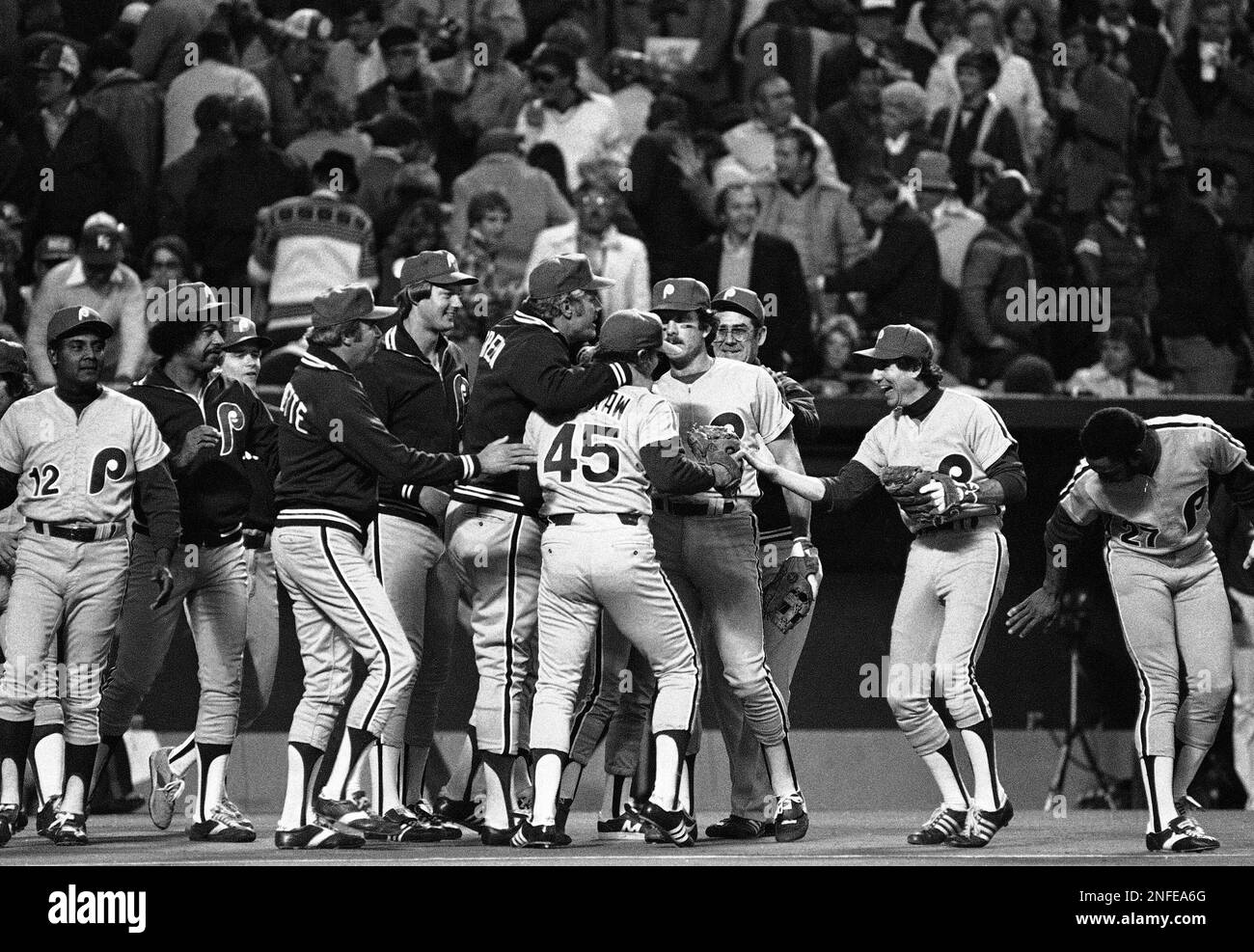 Philadelphia Phillies manager Dallas Green, center, puts his arm around  relief pitcher Tug McGraw (45) as shortstop Larry Bowa, right, comes out to  offer his congratulations after the Phillies won Sunday's World