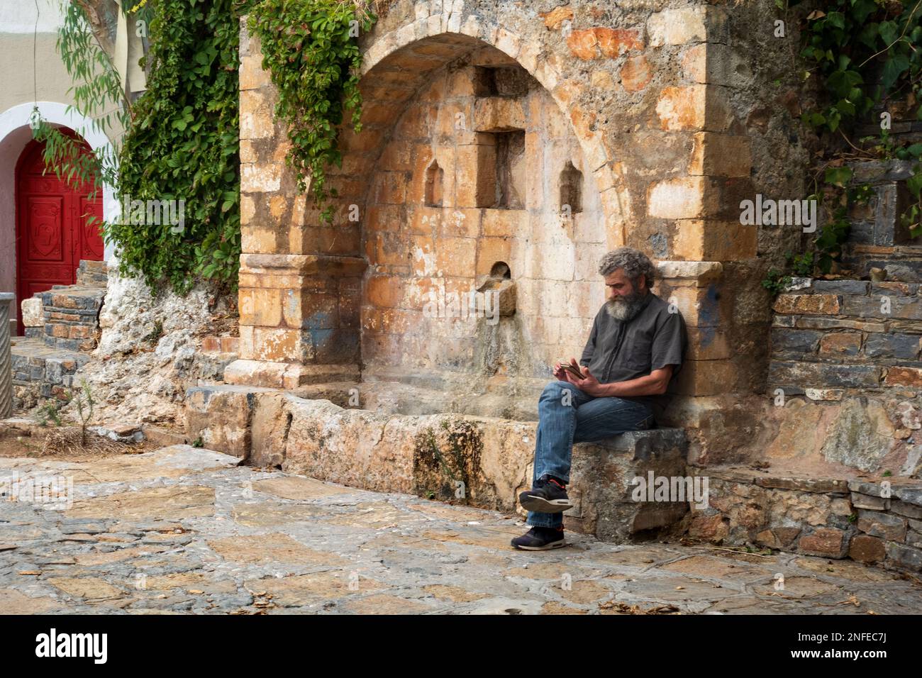 Old greek man sitting hi-res stock photography and images - Alamy
