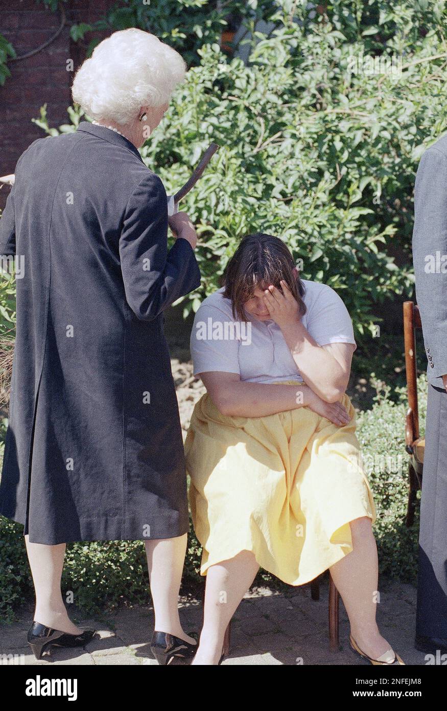 U.S. first lady Barbara Bush comforts a young woman who was overcome with  emotion during a presentation to her at a special village for mentally  handicapped adults, Monday, May 29, 1989 in