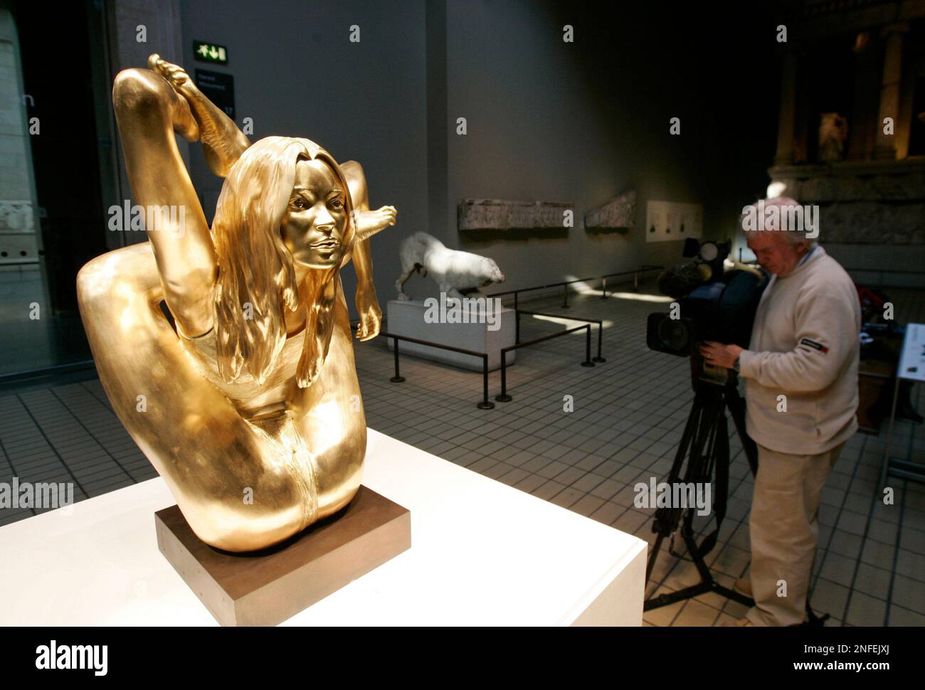 A cameraman films a 50 kilogram (110 pound) solid gold sculpture of British model Kate Moss made