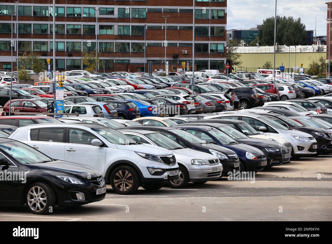 LEEDS, UK - JULY 12, 2016: Large parking lot with parking meters in Leeds, UK. Leeds urban area has 1.78 million population. Stock Photo