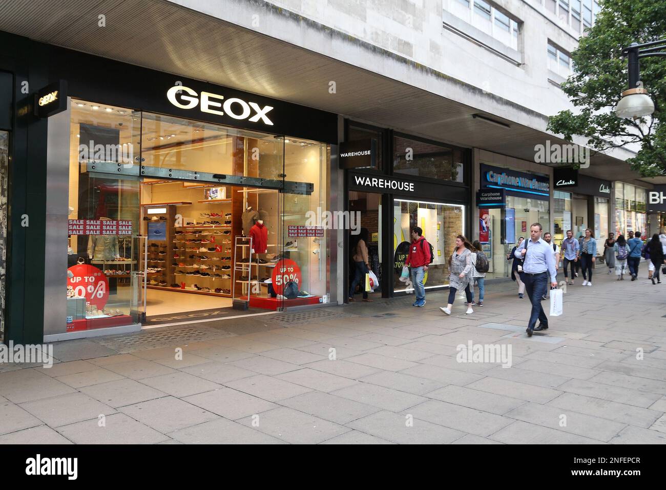 LONDON, UK JULY 6, 2016: People shop at Geox footwear store Oxford Street in London. Oxford Street has approximately half a visitors a Stock Photo Alamy