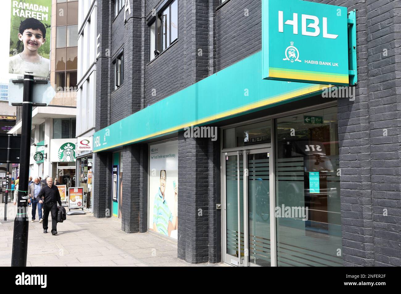 LONDON, UK - JULY 7, 2016: Person walks by Habib Bank UK branch in London. Habib Bank Limited is one of oldest banks from Pakistan. Stock Photo
