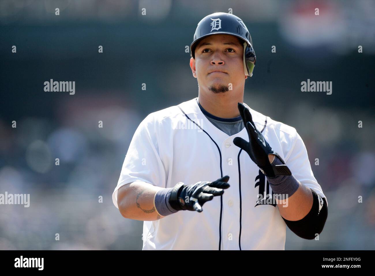 Detroit Tigers' Miguel Cabrera brushed off his gloves after