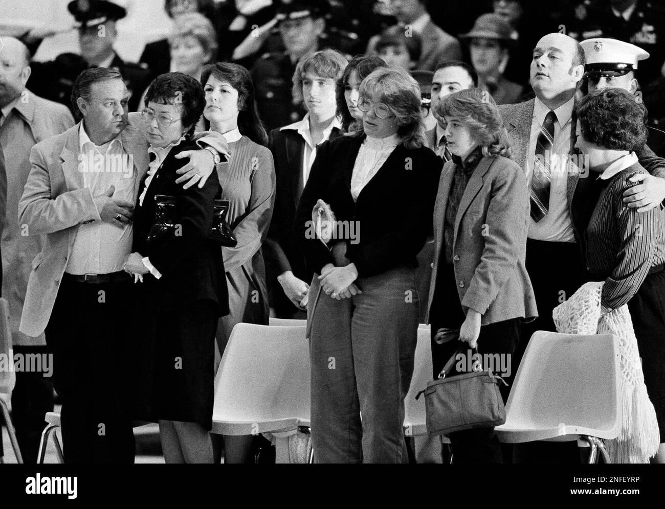 Family members are shown during ceremonies for the returned dead