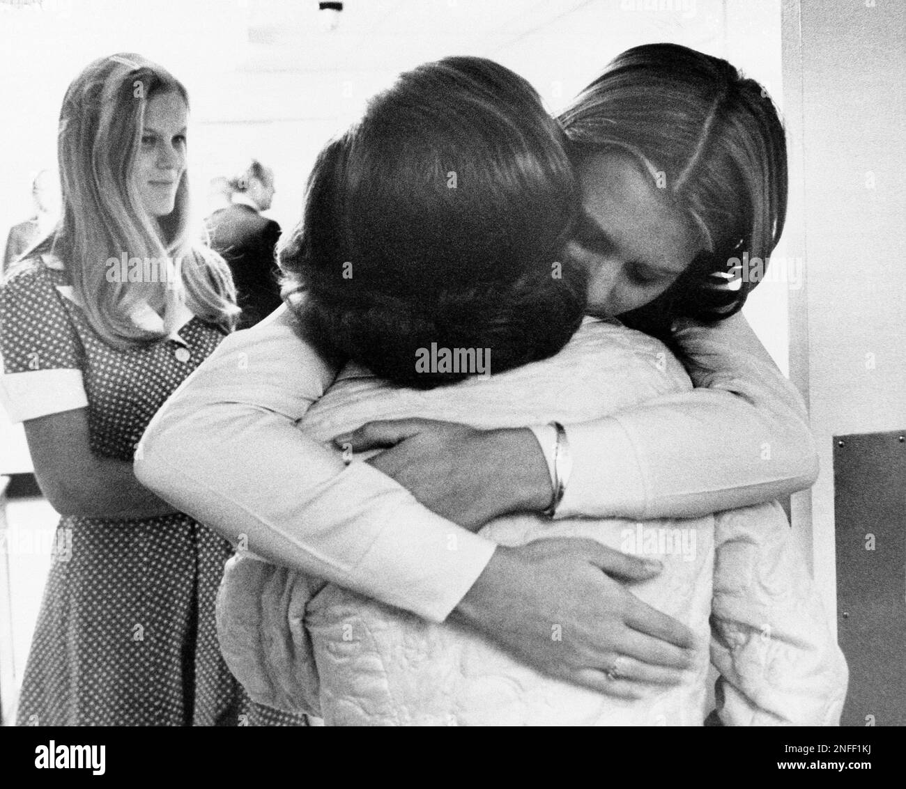 First lady Betty Ford gets a hug from her daughter Susan as members of