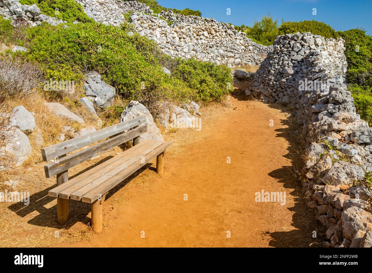 Gagliano del Capo. From a bench you can admire the beautiful panorama of the blue sea, on the rocky cliff of Salento. Nature trail that leads from the Stock Photo