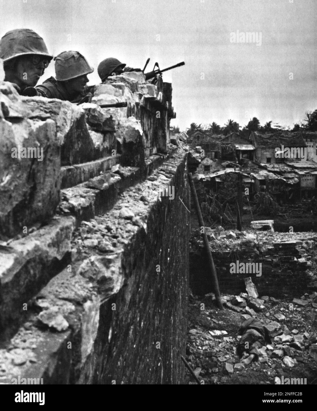 US Marines position themselves atop a tower in Hue's Citadel. A slain ...