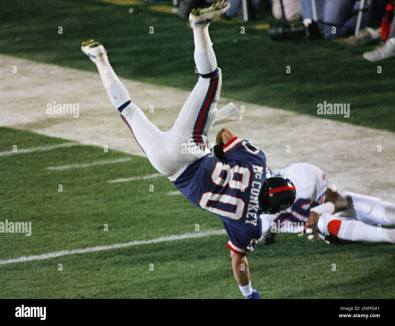 New York Giants Phil McConkey (80) flips through the air as he was