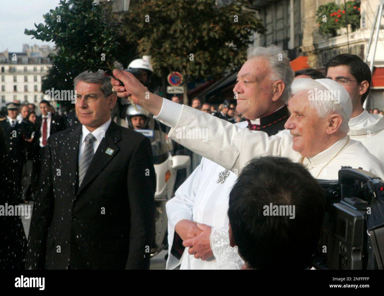 Pope Benedict XVI, right, blesses the crowd as he arrives at Notre Dame ...