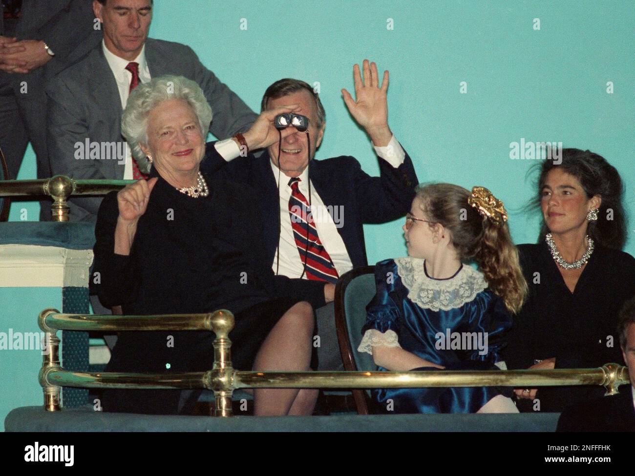 U.S. President Bush looks through a pair binoculars as he and