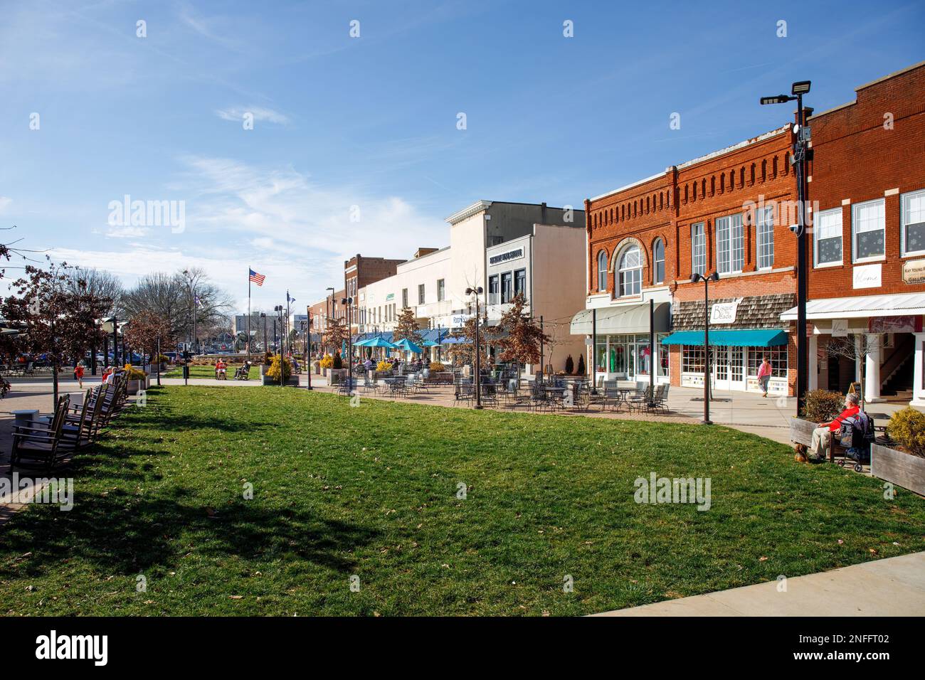 HICKORY, NC, USA-14 FEB 2023: Downtown plaza with outdoor dining, shoppers, green space, storefronts, on sunny winter day. Stock Photo
