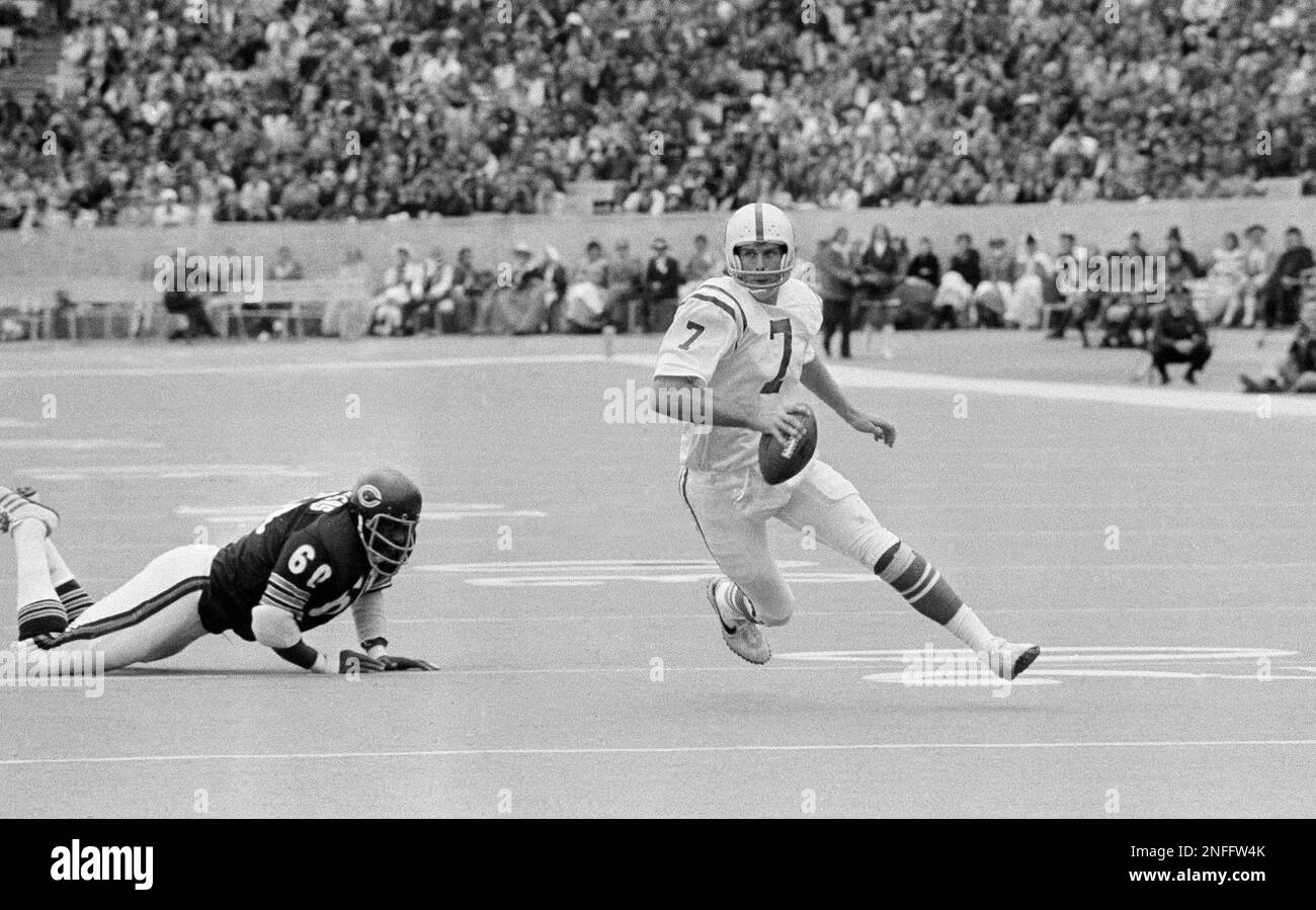 Baltimore Colts quarterback Bert Jones tucks the ball and ducks under the  pressure of Steelers defensive end L.C. Greenwood (68) and linebacker Jack  Ham (59) during first quarter action in Pittsburgh, Dec.