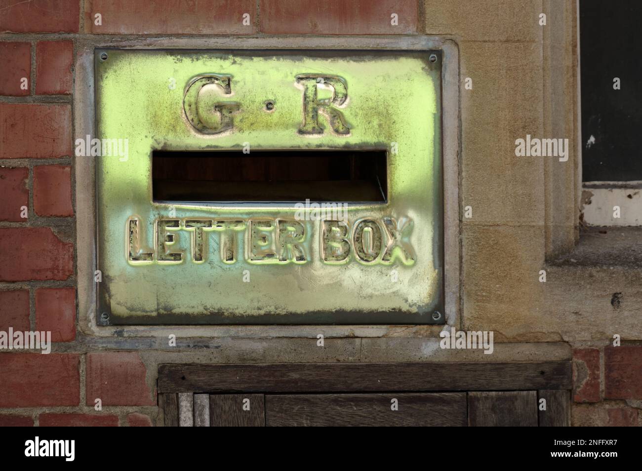 Brass letter box in the wall of the old post office in Winslow, Bucks