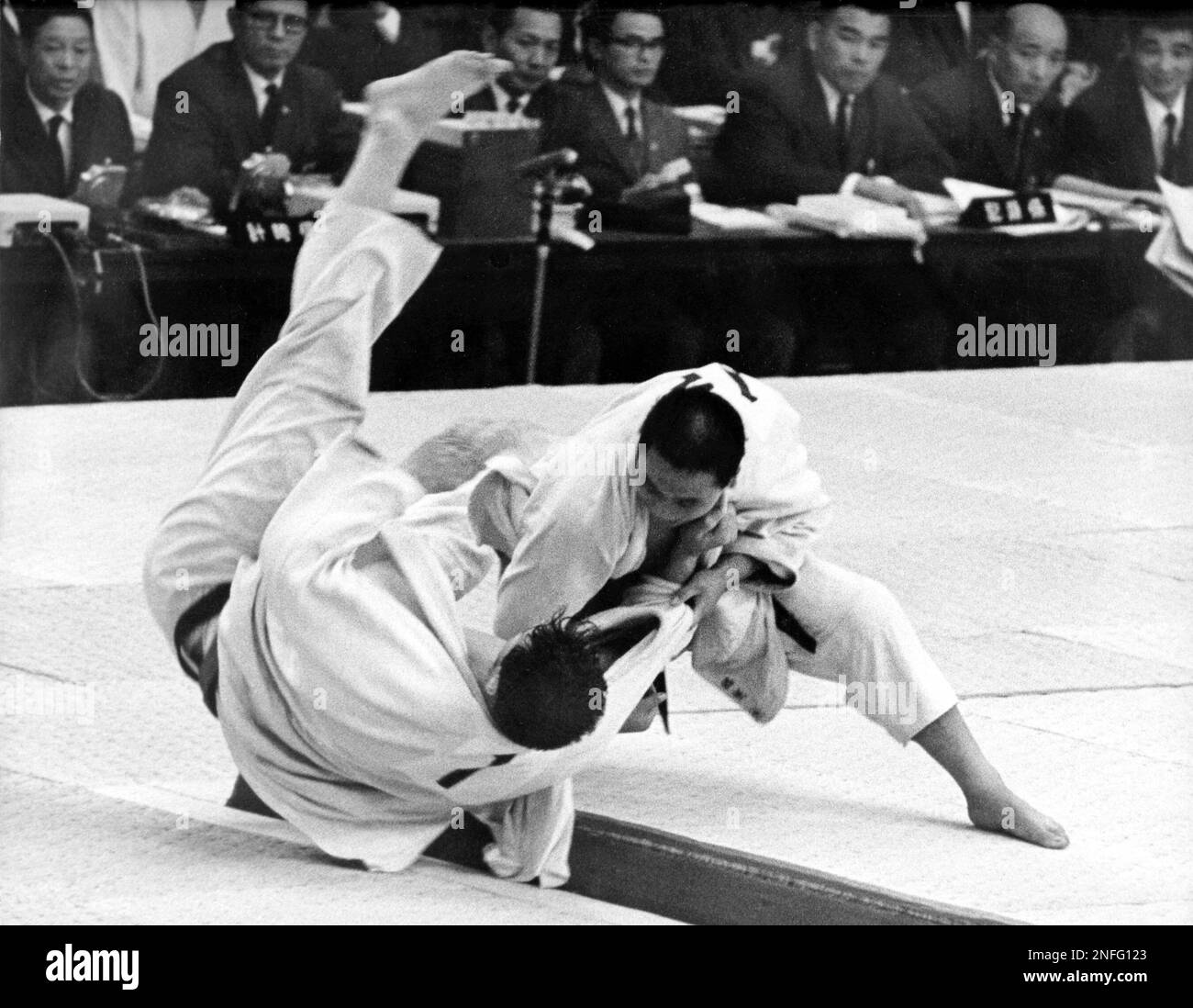 Isao Inokuma, right of Japan throws Canadian Doug Rogers during