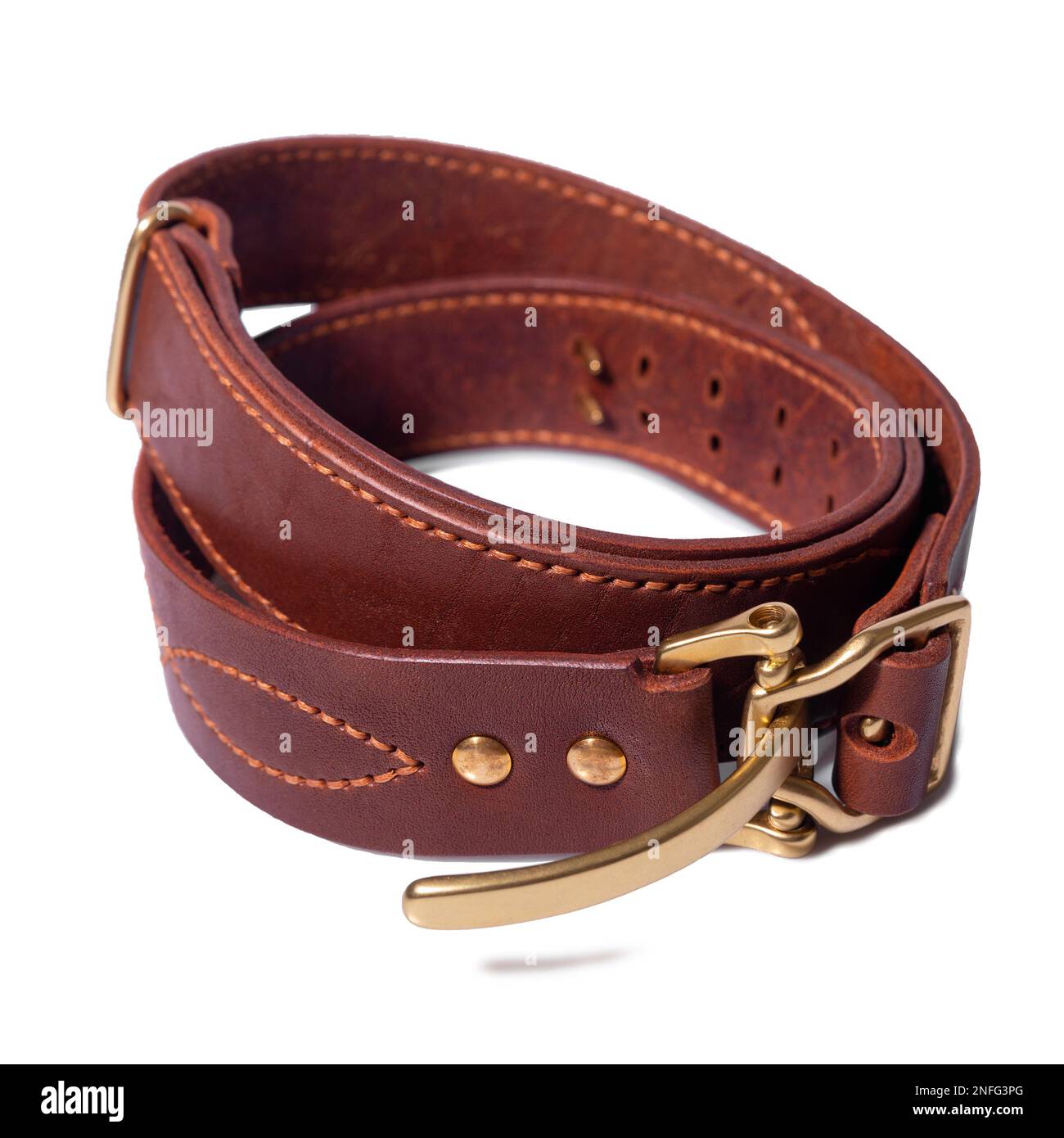 A rolledup brown leather belt with a metal buckle on a white