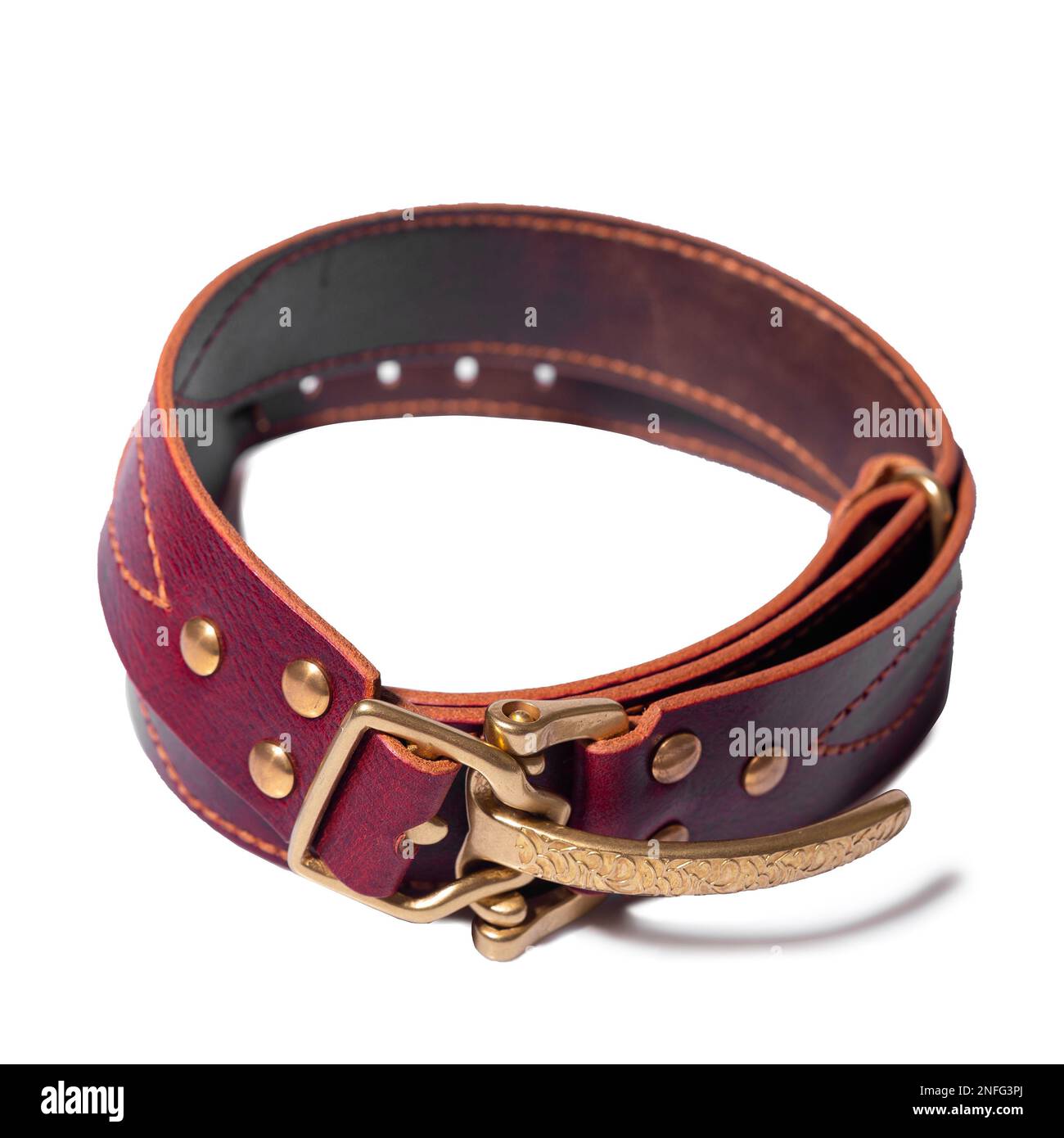 A rolledup brown leather belt with a metal buckle on a white