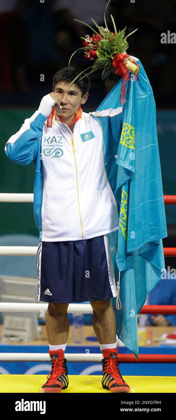 Gold medalist Bakhyt Sarsekbayev of Kazakhstan reacts with his medal on