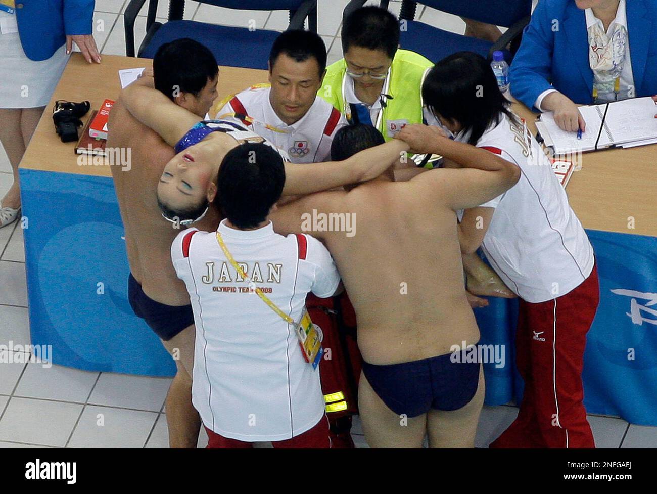 Hiromi Kobayashi, a 23-year-old from Osaka competing in her first Olympics,  is taken out of the pool after hyperventilating during the team  synchronized swimming team free routine at the Beijing 2008 Olympics