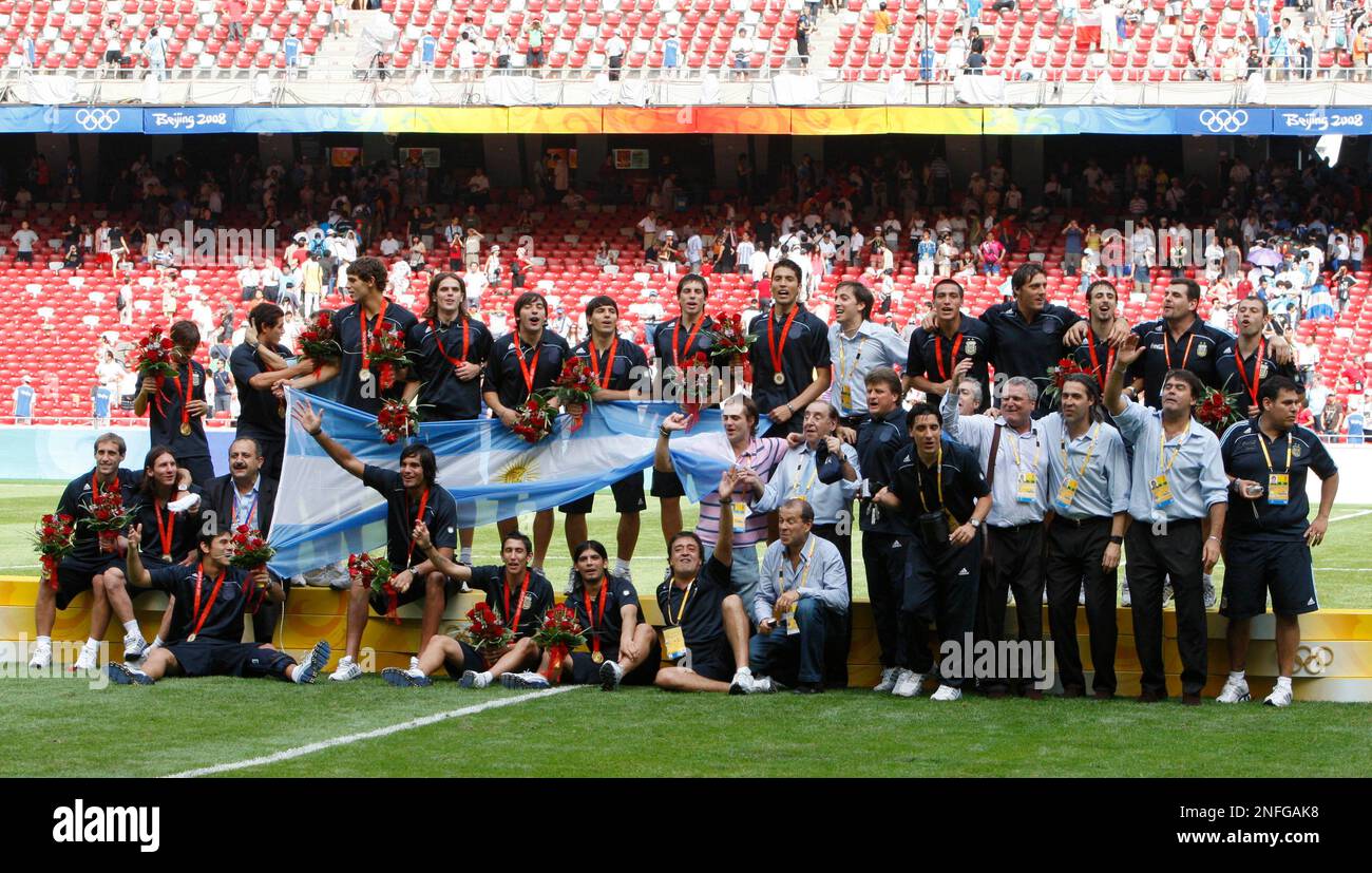The Argentine team celebrate after receiving their medals after winning