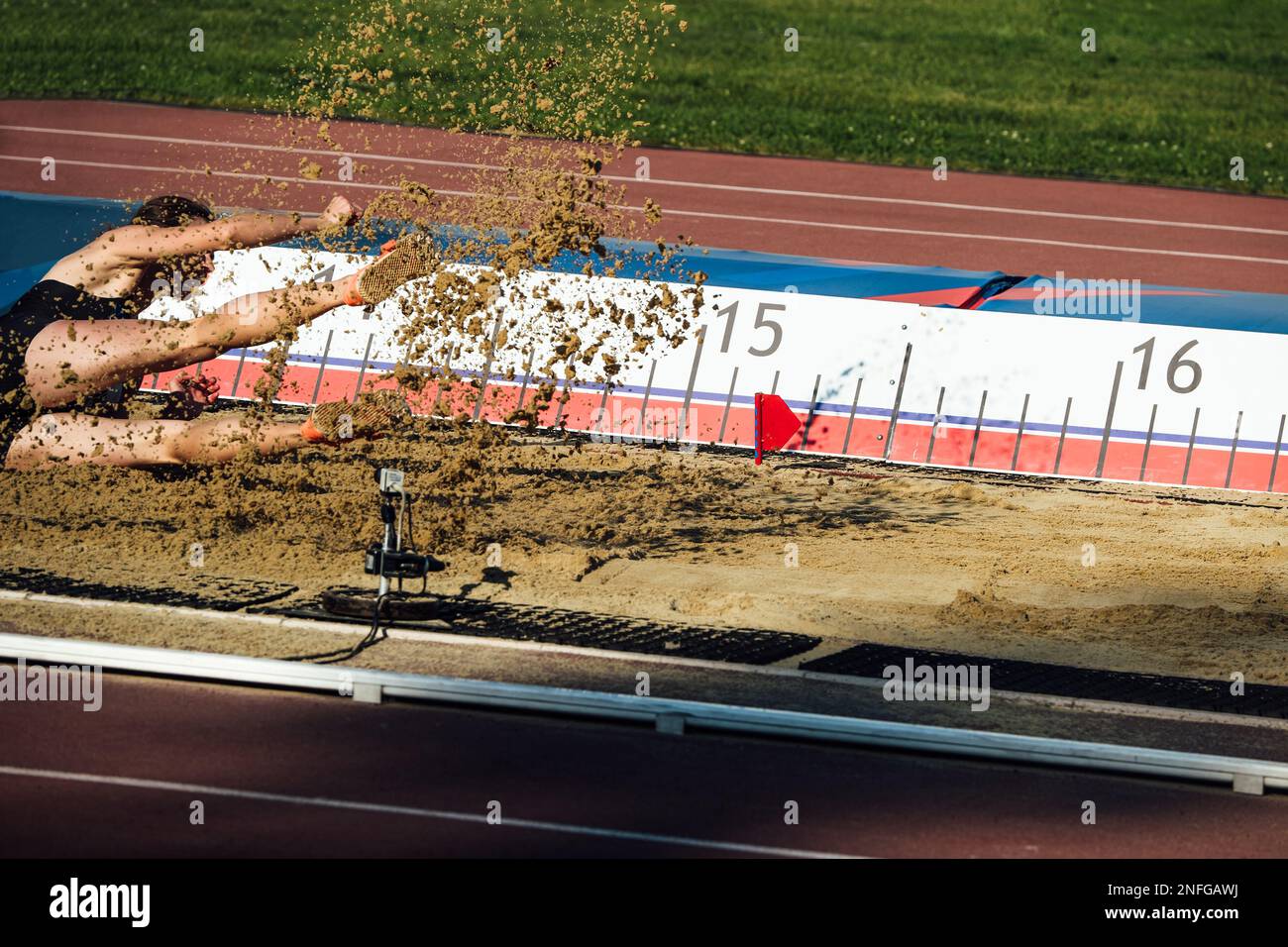 landing in sand male athlete triple jump Stock Photo Alamy