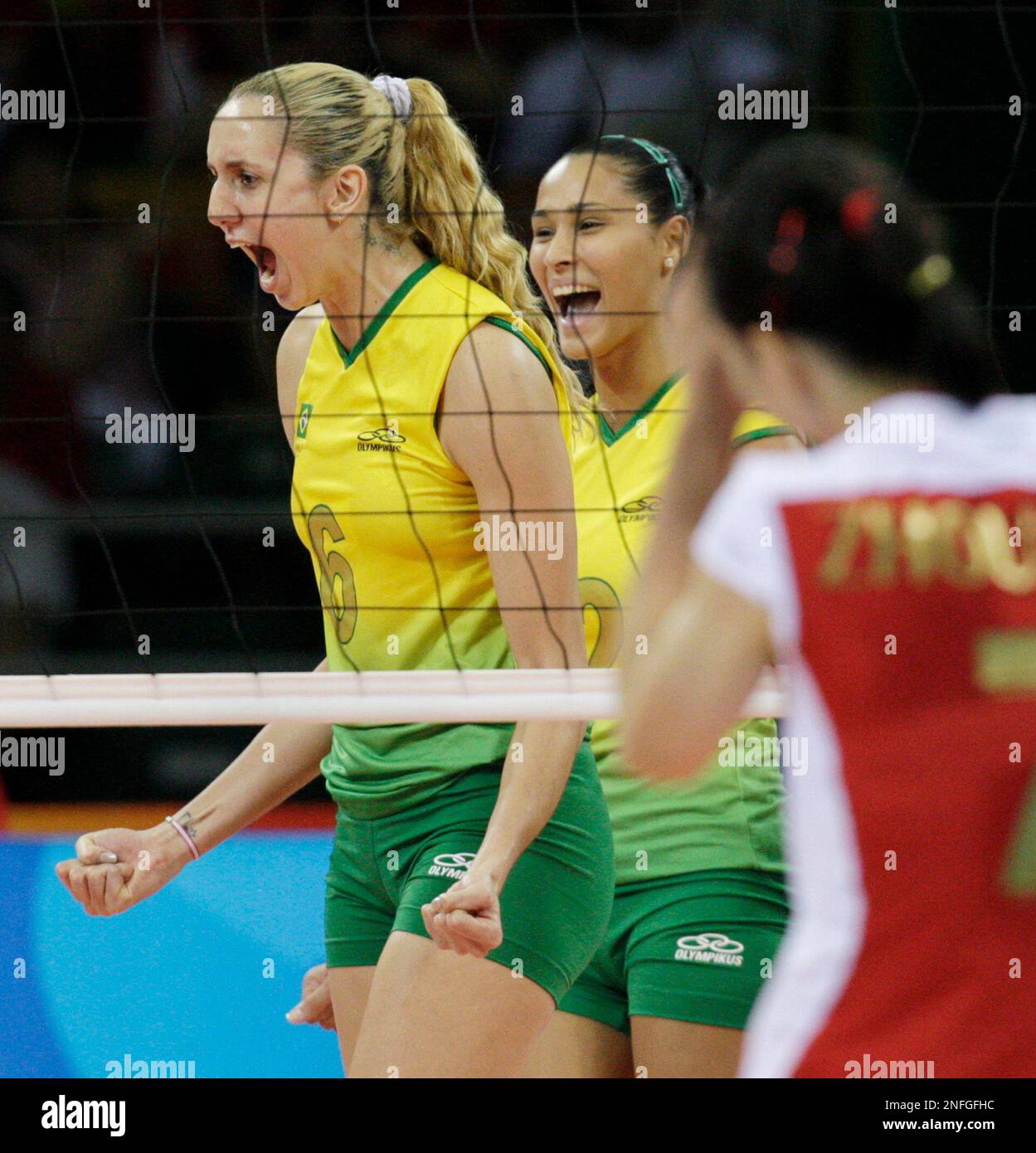 Brazil's Thaisa Menezes (6) and Jaqueline Carvalho celebrate after they scored a point against China during their women's volleyball semifinals match at the Beijing 2008 Olympics in Beijing, Thursday, Aug. 21, 2008. (AP Photo/Andy Wong) Stock Photo