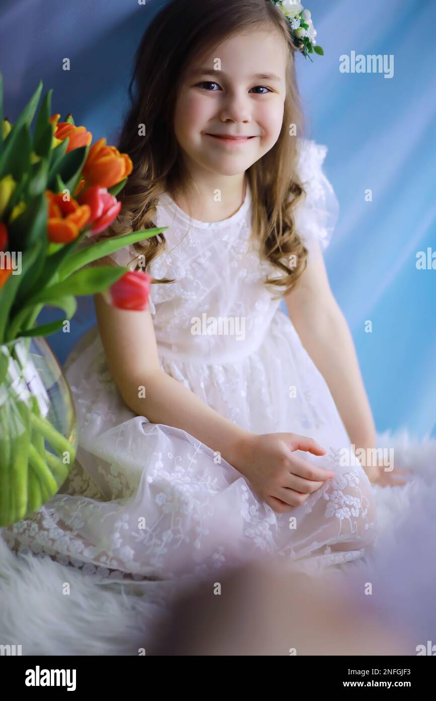 Beautiful girl in white dresses with a magnificent bouquet of first ...