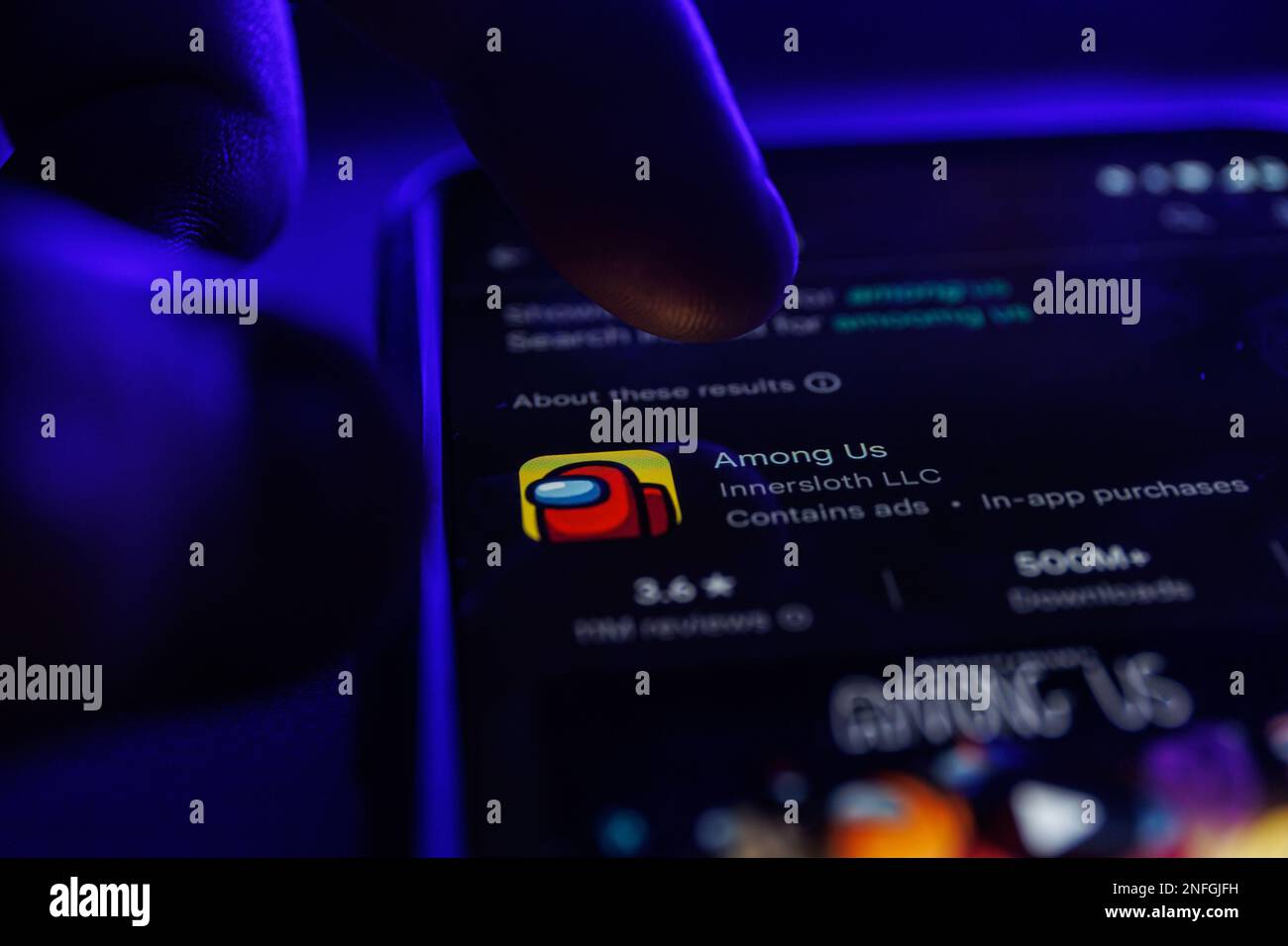 Among Us game app on smartphone screen. Close up shot of Among Us game