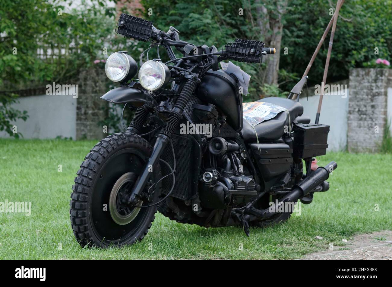 Honda Gold Wing customised survival bike with semi off-road tyres, twin headlights on stalks, hand guards and all over matt black paint job. Stock Photo