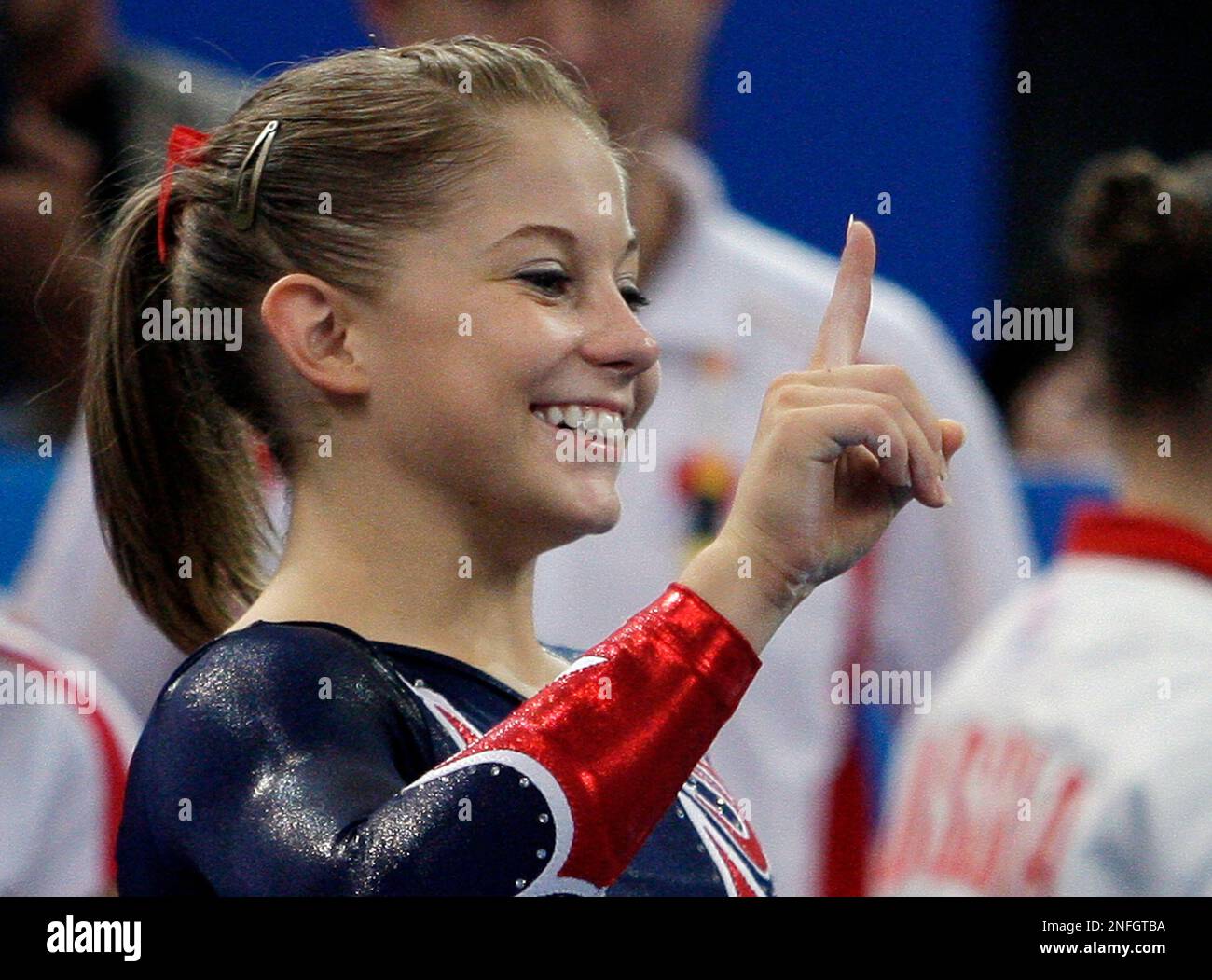 U.S. gymnast Shawn Johnson gestures after performing on the balance beam during the gymnastics