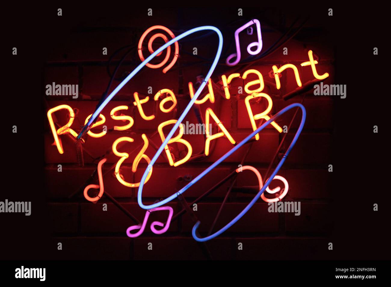 A neon light shaped into the phrase 'Restaurant & Bar'. Stock Photo