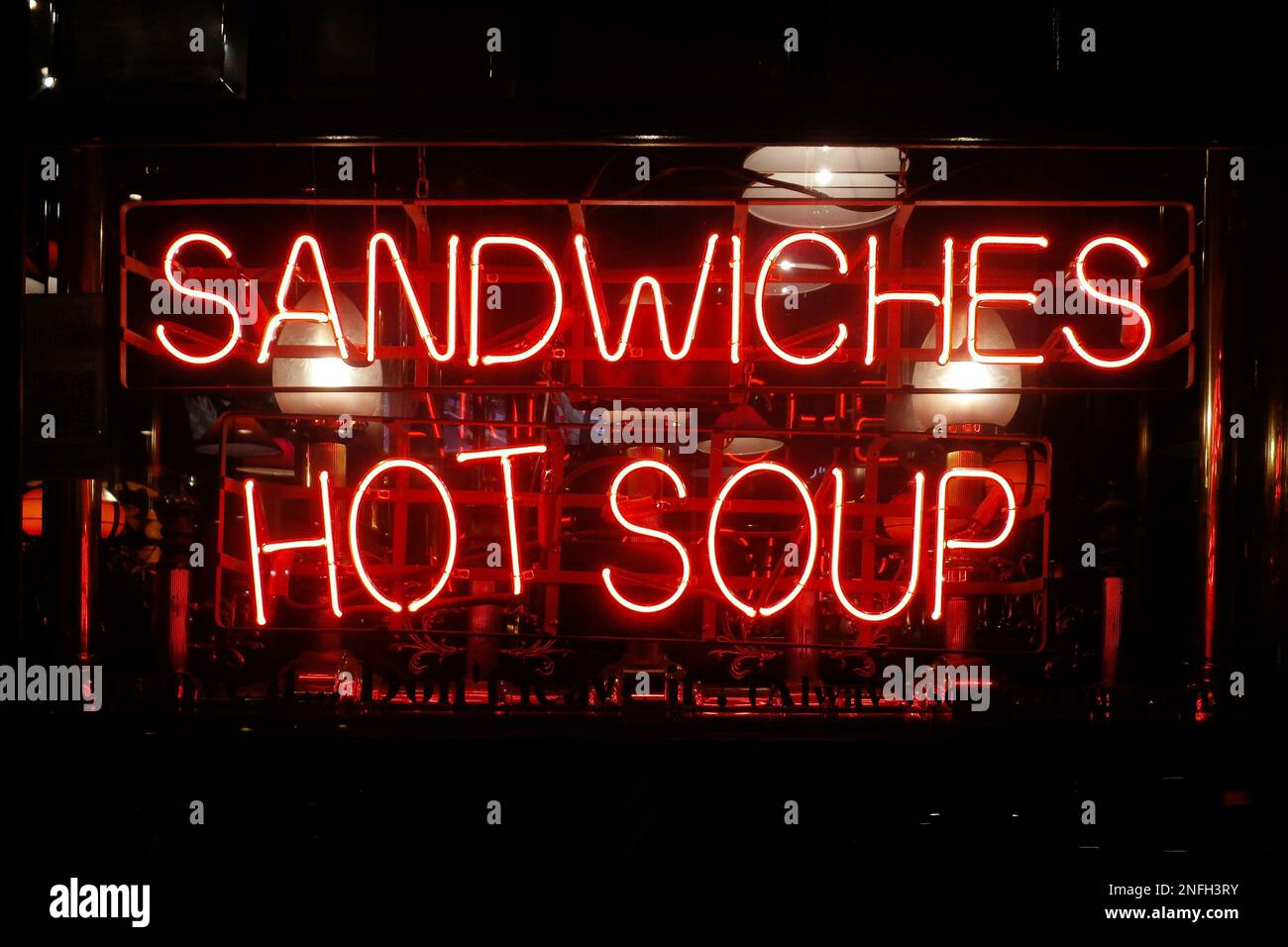 Close-up on a neon light shaped into the short phrase 