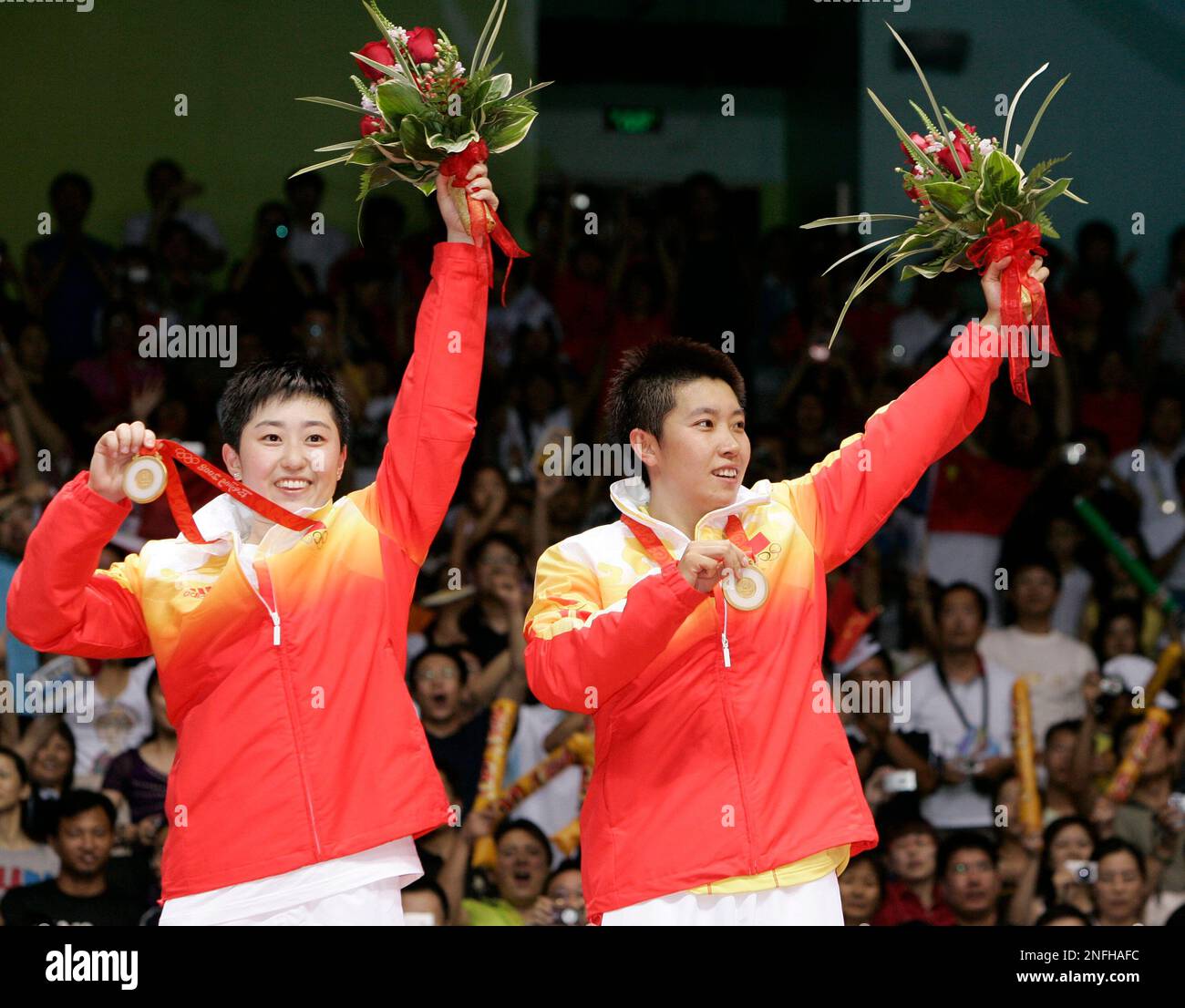 China's Yu Yang, left, and Du Jing, wave to the crowd after receiving ...