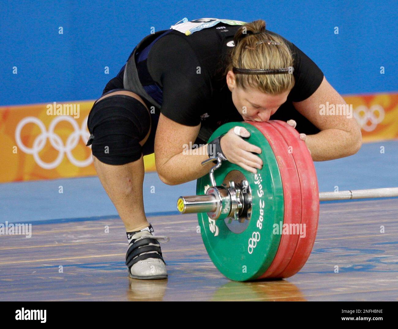 Jeane Lassen, of Canada, kisses the barbell after failing a lift in the  women's 75 kg of the weightlifting competition at the Beijing 2008 Olympics  in Beijing, Friday, Aug. 15, 2008. Lassen