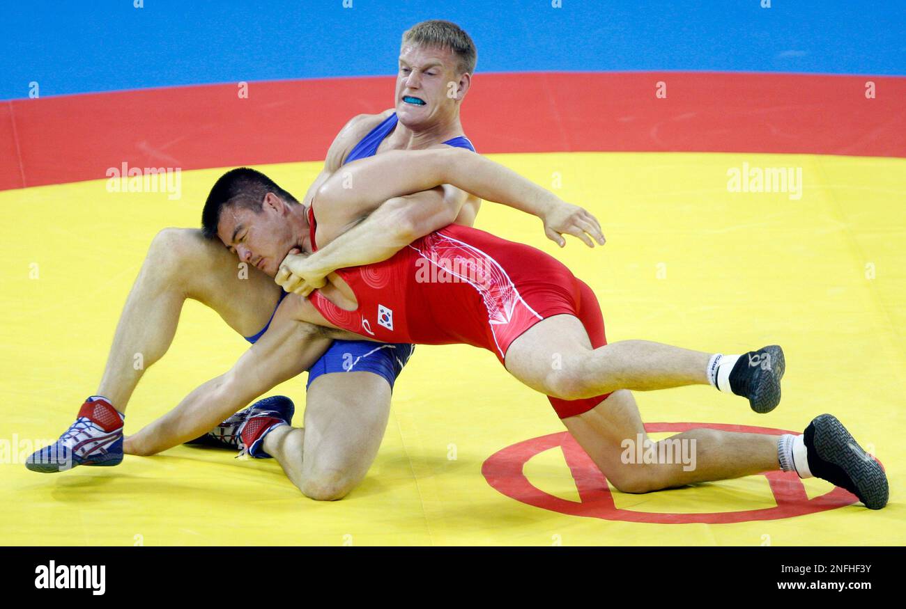USA's Adam Wheeler, blue, wrestles with Korea's Han Tae-Young during ...