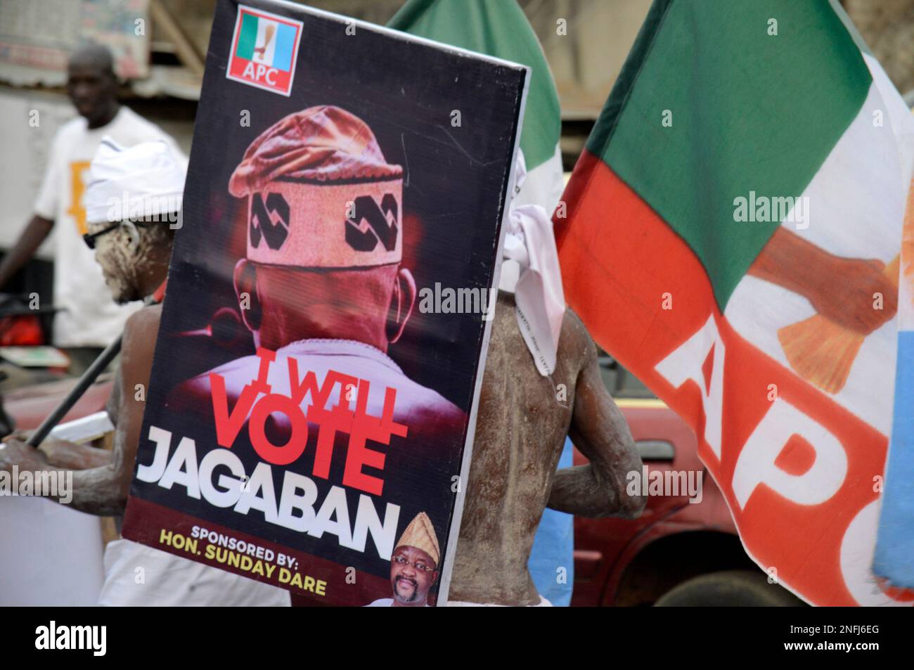 Ibadan, Nigeria February 16, 2023 Supporters of Bola Ahmed Tinubu,  Presidential candidate of All Progressives Congress (APC), carry banner  during the party's presidential campaign in Ibadan, Nigeria, on Thursday,  February 16, 2023., image size:1300x953