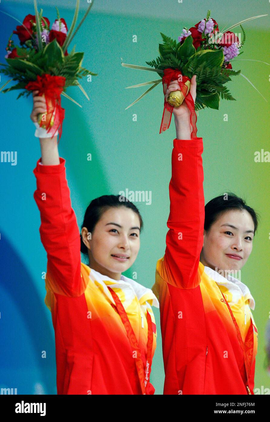 China's Jingjing Guo and Minxia Wu, left, celebrate from the medals ...