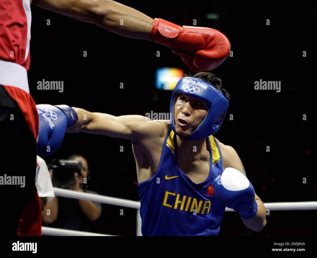 Xiaoping Zhang of China , blue, and Mourad Sahraoui of Tunisia, red