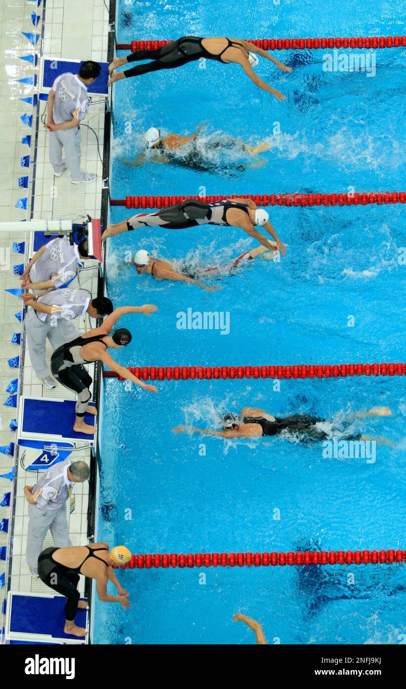 Swimmers compete in a women's 4x100meter freestyle relay during the